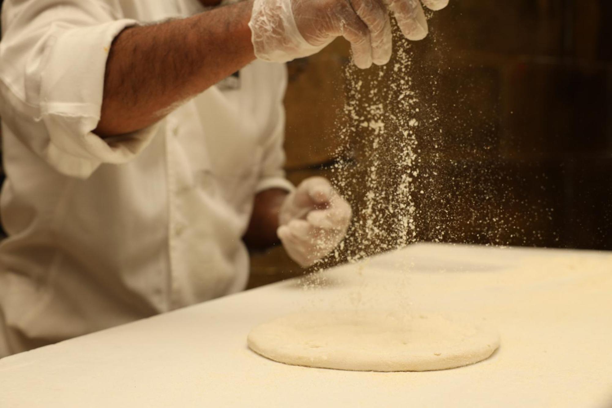 Kempinski Al Othman Hotel Al-Chubar Zewnętrze zdjęcie Dusting a pizza dough with cornmeal